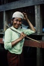 local village woman with a large traditional ax waiting for her lunch to be prepared