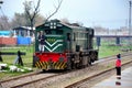 Pakistan Railways locomotive engine passes as small child watches