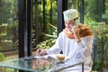 Pakistani business asian man in casual wearing casual write on notebook using smart mobile phone with cup of coffee in cafe,freela Royalty Free Stock Photo