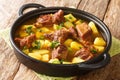 Pakistani cuisine slow stew lamb with potatoes Aloo Gosht closeup in the pan. Horizontal