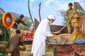 A Pakistani farmer checking quality of wheat grains