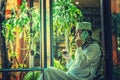 Pakistani muslim business Man talking on cellphone and drinking Royalty Free Stock Photo