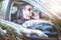 Pakistani muslim Man driving car and talking on cell phone conc Royalty Free Stock Photo