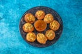 Pakistani spicy gol gappay, indian pani puri and bangali fuchka full of chaat masala with sour water in a dish isolated on marble