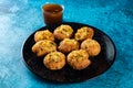 Pakistani spicy gol gappay, indian pani puri and bangali fuchka full of chaat masala with sour water in a dish isolated on marble