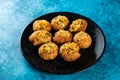 Pakistani spicy gol gappay, indian pani puri and bangali fuchka full of chaat masala with sour water in a dish isolated on marble