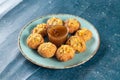 Pakistani spicy gol gappay, indian pani puri and bangali fuchka full of chaat masala with sour water in a dish isolated on marble