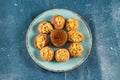 Pakistani spicy gol gappay, indian pani puri and bangali fuchka full of chaat masala with sour water in a dish isolated on marble