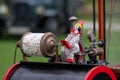 Old popcorn machine decoration - a clown spins a transparent barrel with popcorn