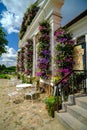 Pakruojis, Lithuania. July 7 , 2023: Old style garden furniture near a small restaurant. Walls with beautiful multi Royalty Free Stock Photo