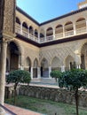 Palace of Alcazar, famous Andalusian architecture, an old Arab place in Seville, Spain. ornamented arch and column Royalty Free Stock Photo