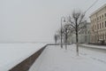 Palace Embankment and Hermitage Bridge in snowfall. Winter in St. Petersburg