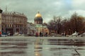 Palace square in St. Petersburg with a view of the dome of St. Isaac`s Cathedral, reflection in puddles, spring Royalty Free Stock Photo