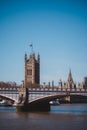 Palace of Westminster behind the Lambeth Bridge with a flag half-mast on sunny day