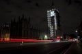 The Palace of Westminster and illuminated Big Ben at night with light trail Royalty Free Stock Photo