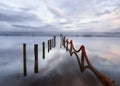 Palafitic pier submerged at sunset whit red rope