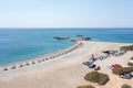 Palaiochora town, Crete Greece, pebble beach with umbrella. Aerial drone view of crystal clear sea