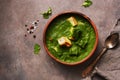 Palak paneer or Spinach and Cottage cheese curry on a dark background. Traditional Indian food. Top view, copy space Royalty Free Stock Photo