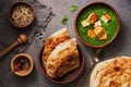 Palak paneer or Spinach and Cottage cheese curry,mortar with spices , naan, rice on a dark background. Traditional Indian food. Royalty Free Stock Photo
