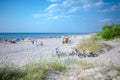 Palanga, Lithuania - Aug 03: People are relaxing on sandy beach of the Baltic sea. Seaside resort at warm summer day on Baltic sea