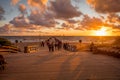 Tourists are watching a sunset at a famous marine Palanga pier on the Baltic sea in the resort city Palanga, Lithuania