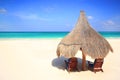 Palapa thatch umbrella and chairs on beach Royalty Free Stock Photo