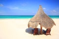 Palapa thatch umbrella and chairs on beach