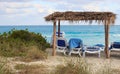 Palapas and lounge chairs overlooking the ocean n Royalty Free Stock Photo