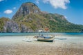 Palawan island, Philippines. Low angle view of traditional filippino boat in shallow water in El Nido bay. Epic Cadlao Royalty Free Stock Photo