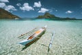 Palawan, Philippines. Traditional small fishing banca boat in front of Cadlao Island in crystal clear shallow water Royalty Free Stock Photo