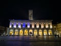 Palazzo del Podesta and Piazza Maggiore city square in Bologna with tourists at night and nice backlight