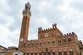 Palazzo Pubblico and the tower Torre del Mangia in the city square Piazza del Campo Royalty Free Stock Photo