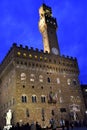 Palazzo Vecchio illuminated by the lights on for the evening that advances, but with the sky still blue, in Florence. Royalty Free Stock Photo