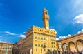 Palazzo Vecchio palace with bell tower with clock and Loggia dei Lanzi on Piazza della Signoria square in historical centre of Flo