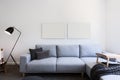 Pale blue linen sofa and blank pictures in a living room Royalty Free Stock Photo