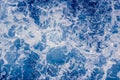 Pale blue sea surface with waves and foam, abstract background Royalty Free Stock Photo