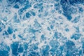 Pale blue sea surface with waves and foam, abstract background Royalty Free Stock Photo