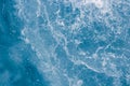 Pale blue sea surface with waves, splash, foam and bubbles at high tide and surf, abstract background Royalty Free Stock Photo