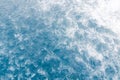 Pale blue sea surface with waves, splash,  white foam and bubbles at high tide and surf, abstract background Royalty Free Stock Photo