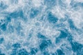 Pale blue sea surface with waves, splash,  white foam and bubbles at high tide and surf, abstract background Royalty Free Stock Photo
