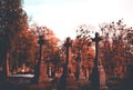 Pale depressive statues, monuments, and gravestones of the cemetery on sunny autumn afternoon. Royalty Free Stock Photo