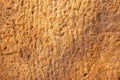 pale intense gradient old weathered rich multi earth tones uneven textured sandstone wall with natural carvings, texture Royalty Free Stock Photo