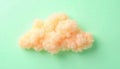 Delicate, fluffy, pale orange cloud shape on a mint green background Royalty Free Stock Photo
