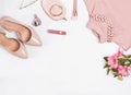 Pale pink feminine accessories and flowers on the white background.