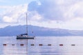 Pale purple sea, boat and mountains at sunrise. Coastal nature background