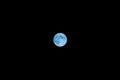 Pale, visibly blue moon in the night sky Royalty Free Stock Photo