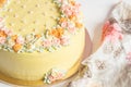 Pale yellow mousse cake with pastel cream flowers Royalty Free Stock Photo