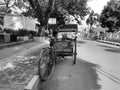 Palembang - Indonesia, 06/16/2020: portrait of a traditional Indonesian rickshaw driver in an environmentally friendly vehicle