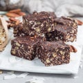 Paleo chocolate energy bars with rolled oats, pecan nuts, dates, chia seeds and coconut flakes, square Royalty Free Stock Photo