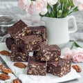 Paleo chocolate energy bars with rolled oats, pecan nuts, dates, chia seeds and coconut flakes, square Royalty Free Stock Photo